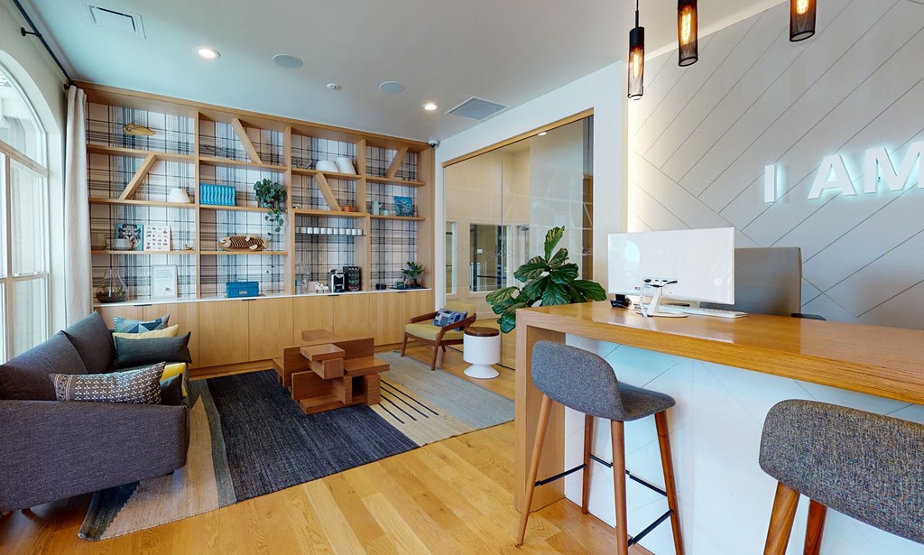 the lobby of an office with a desk and chairs