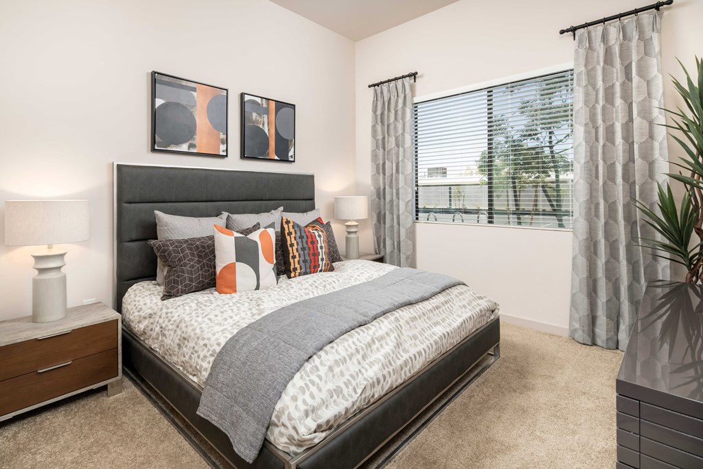 our apartments offer a bedroom with a bed and a large window