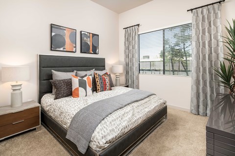 our apartments offer a bedroom with a bed and a large window