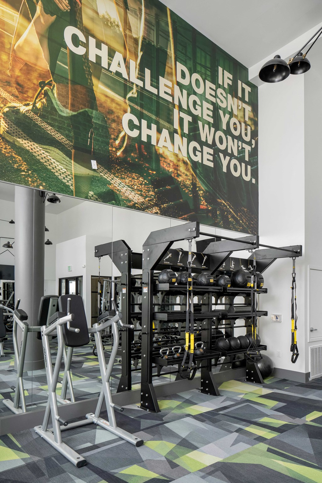 a gym with weights and a poster on the wall