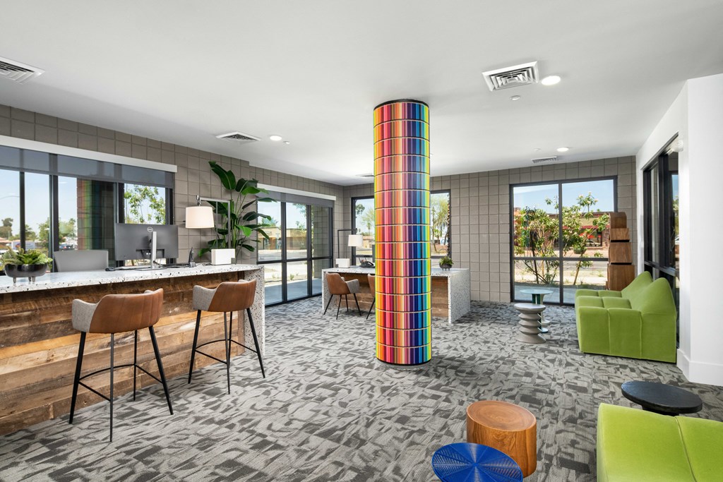 a lobby with a colorful column in the middle of a room