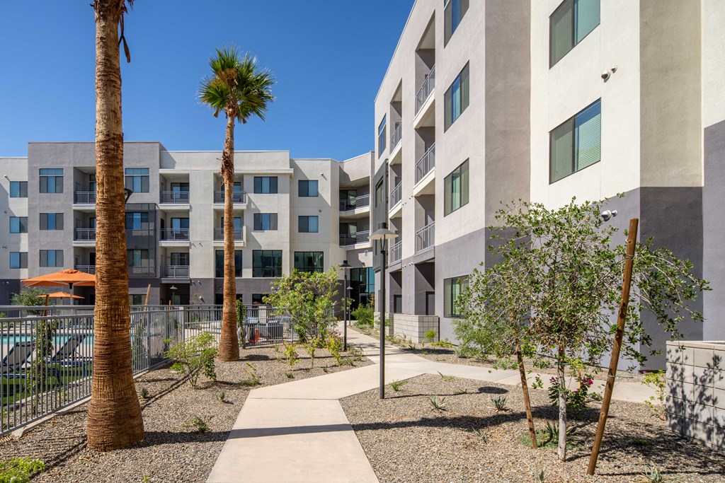 an apartment building with a courtyard and palm trees