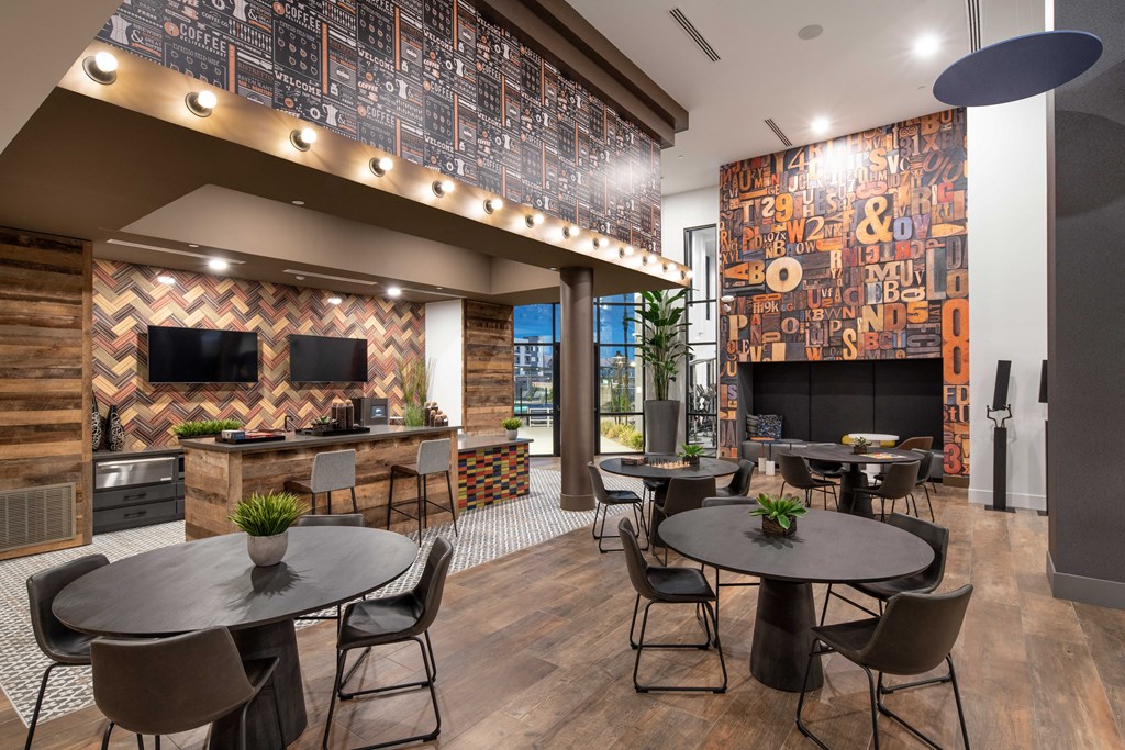 a restaurant with tables and chairs and a bar and a television