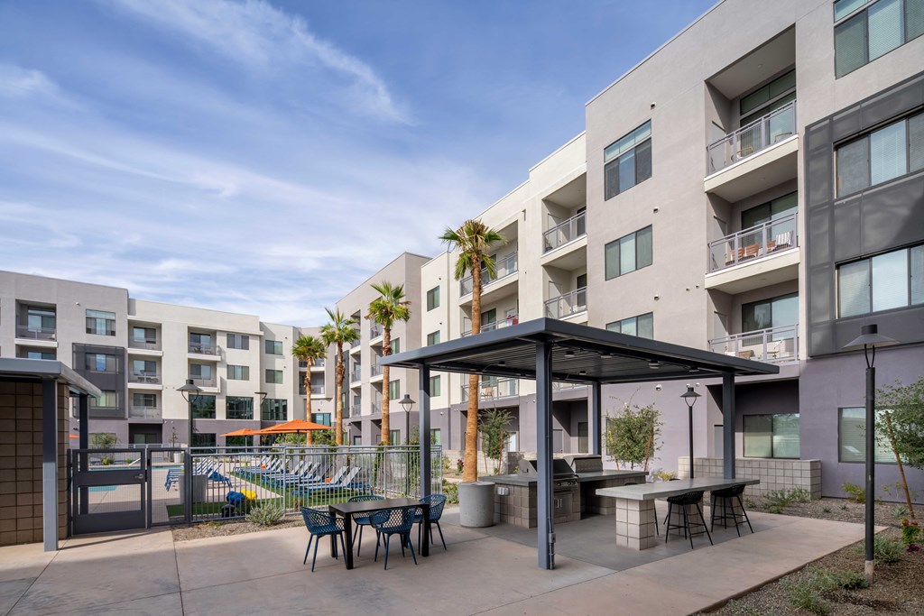 our apartments have a large patio with tables and chairs and a pool