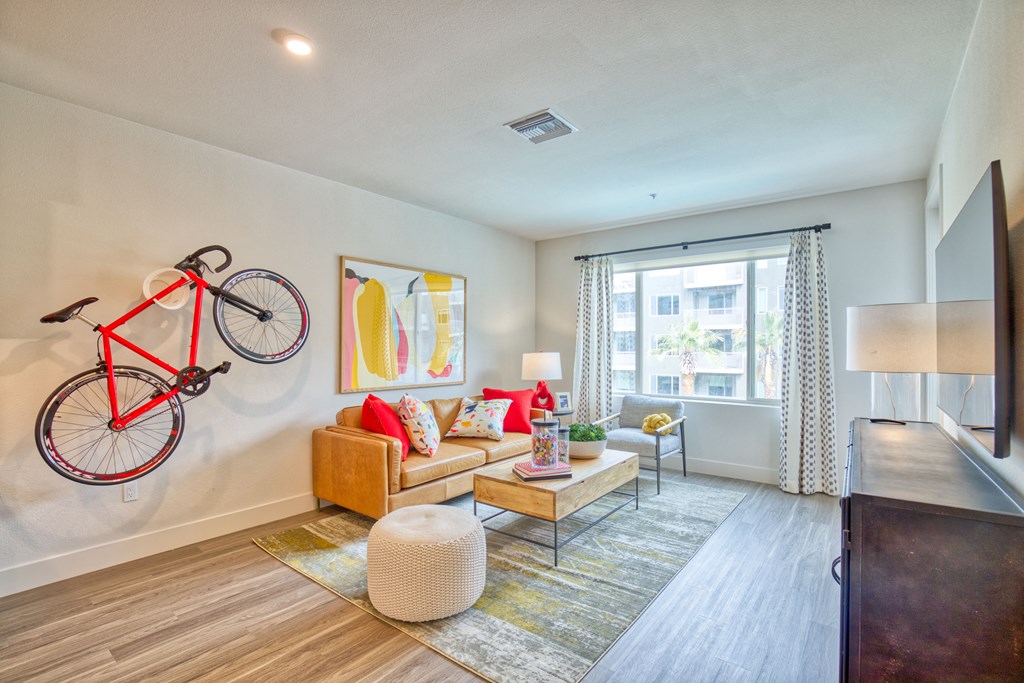 a living room with a couch and a bike on the wall