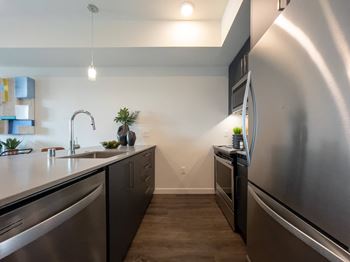 a kitchen with stainless steel appliances and a large counter top