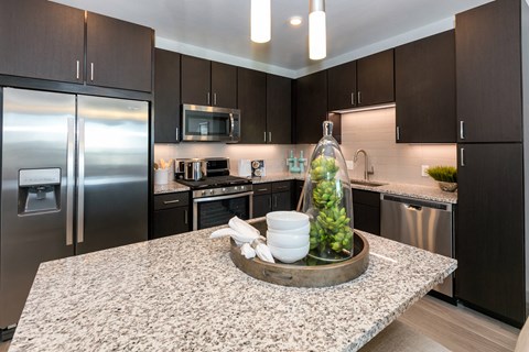 a kitchen with stainless steel appliances and granite counter tops