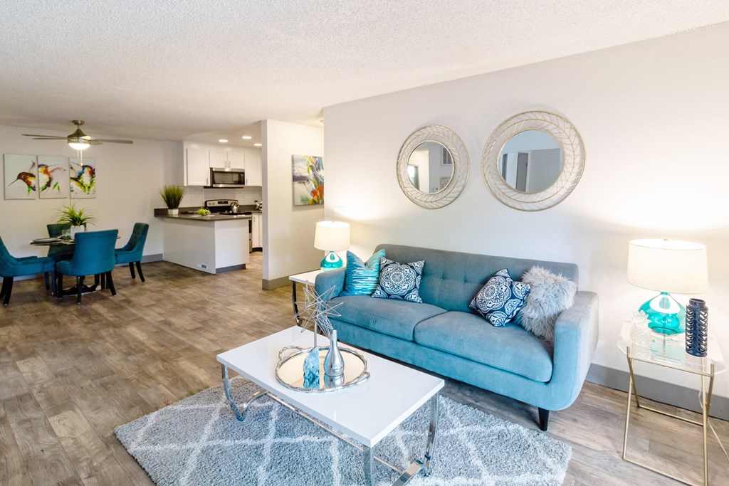 a living room with a blue couch and a coffee table