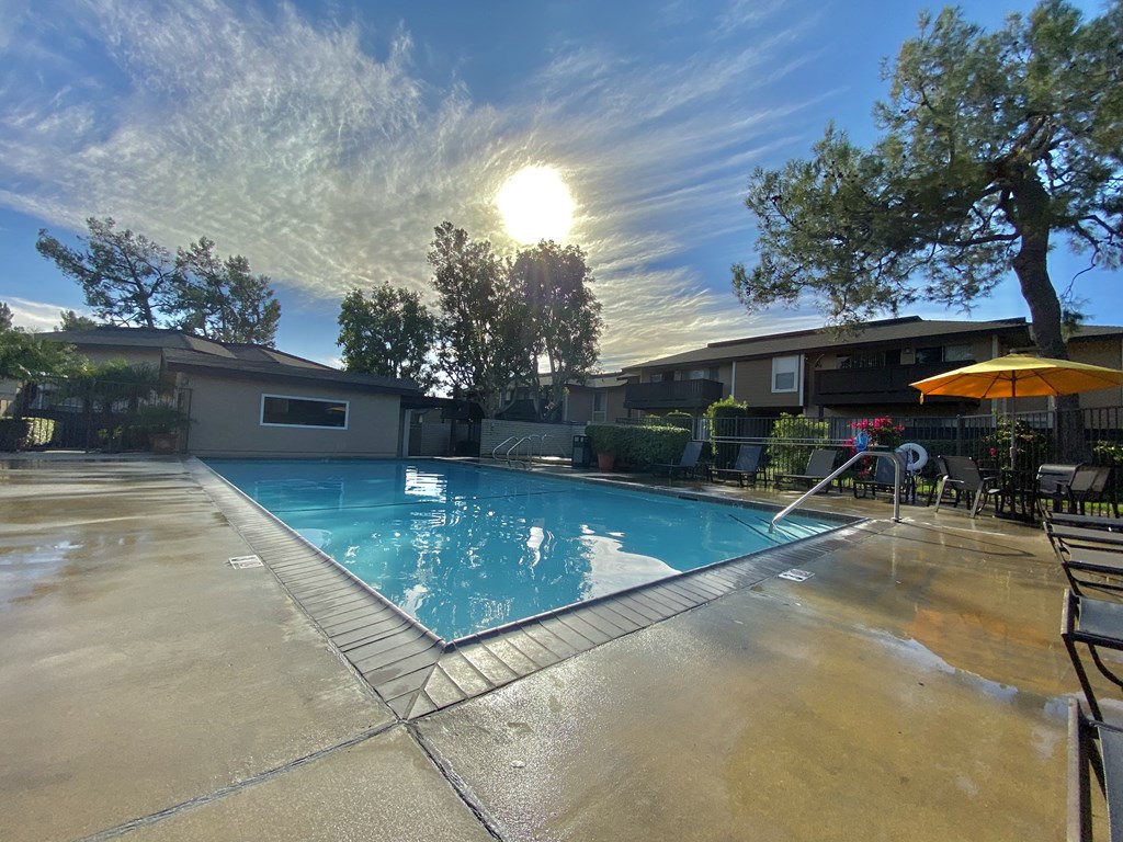 a swimming pool with the sun shining over it