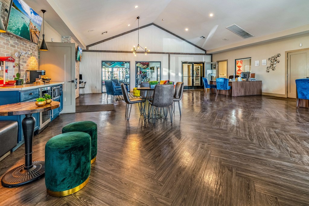 a clubhouse with a dining area and a kitchen with a table and chairs