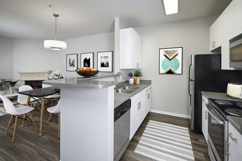 an open kitchen with a large island and a dining table