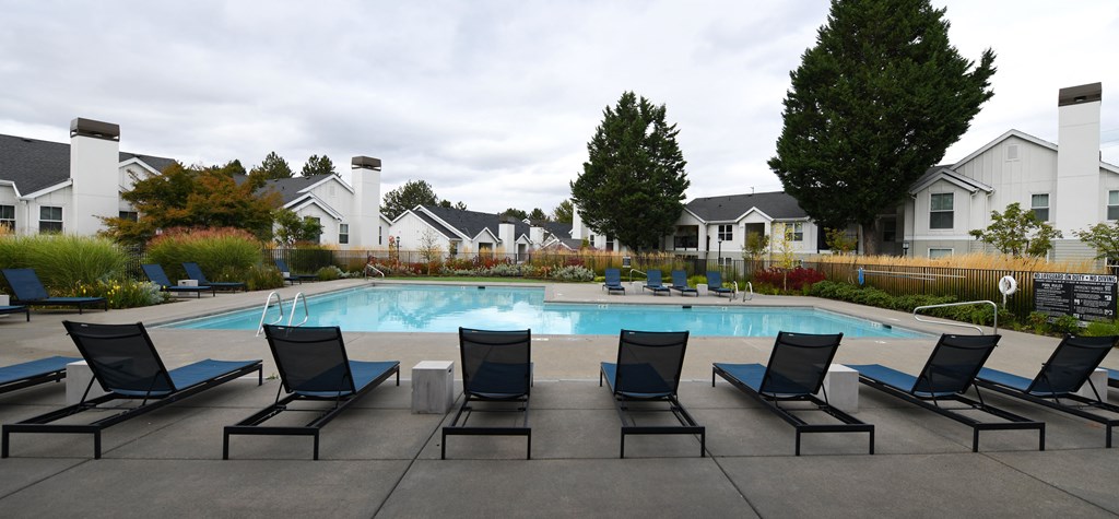 a swimming pool with black lounge