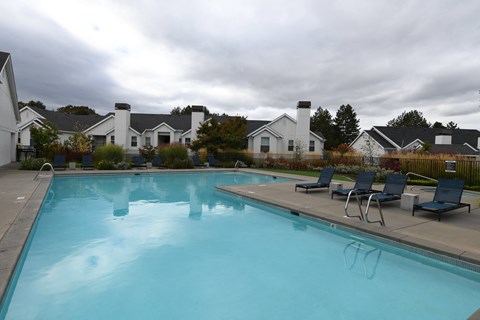 the view of a large swimming pool with chairs