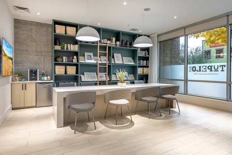 A modern kitchen with a dining table and chairs.