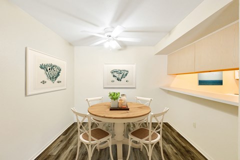 a dining room with a table and chairs and a ceiling fan