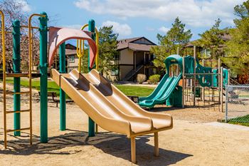 a playground with a slide and other playground equipment
