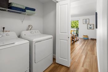 A small laundry room with a washer and dryer.