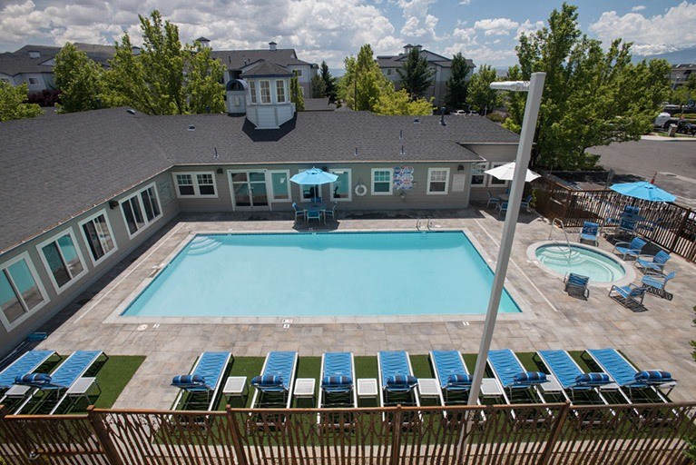 Sparkling pool with sun deck at Marina Village Apartments, NV 89434