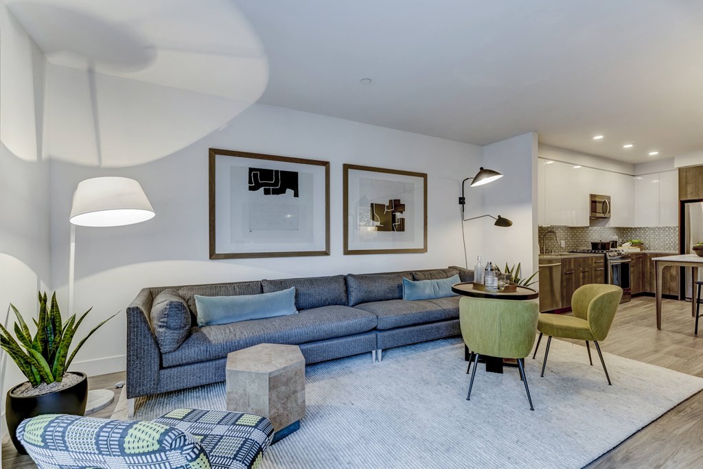 a living room with a blue couch and a round table