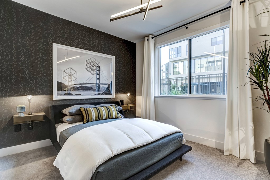 a bedroom with a bed and a window