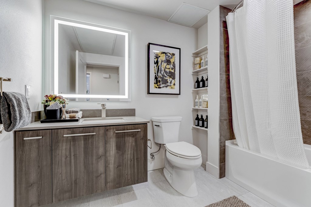 a bathroom with a toilet and a shower and a sink