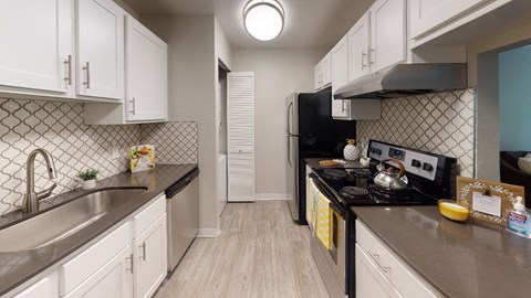 a kitchen with a stove and a sink