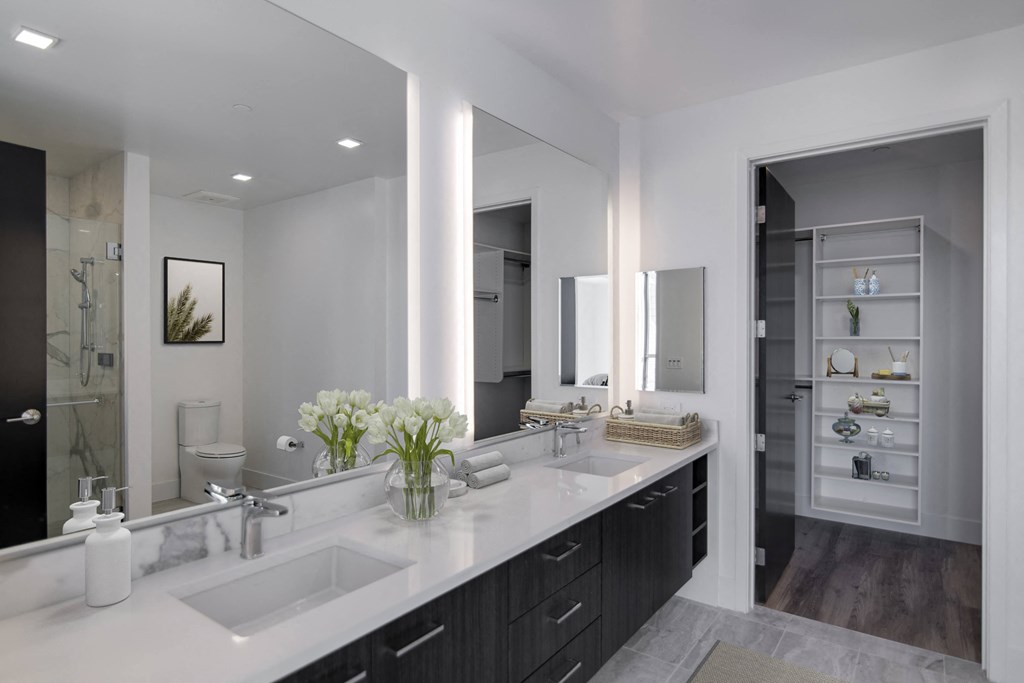 a bathroom with two sinks and a large mirror