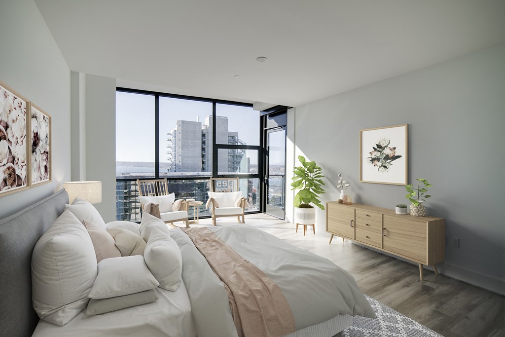 a bedroom with a large bed and a large window