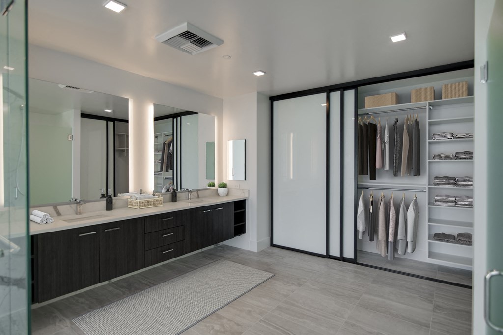 a large bathroom with a large closet and two sinks