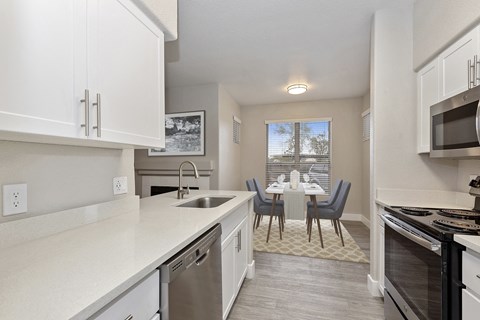 an open kitchen and dining room with a table and chairs