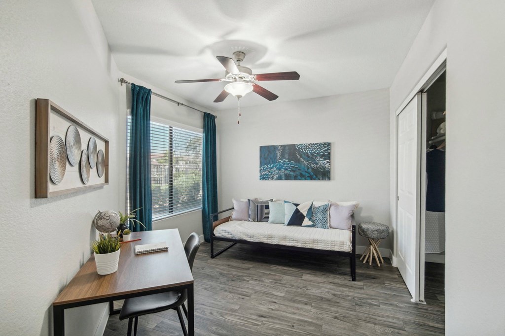 a living room with a ceiling fan and a couch