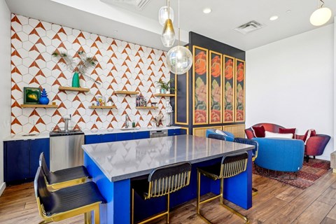 a dining room with a blue table and chairs