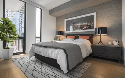 a bedroom with a bed and a painting on the wall