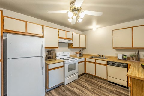 a kitchen with white appliances and wooden cabinets