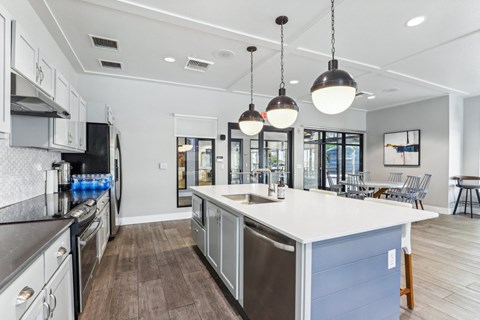 a large kitchen with an island and stainless steel appliances