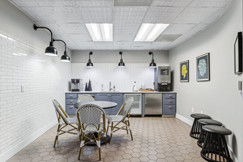 a dining room with a table and chairs and a kitchen