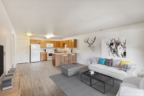 a living room and kitchen with a couch and a table