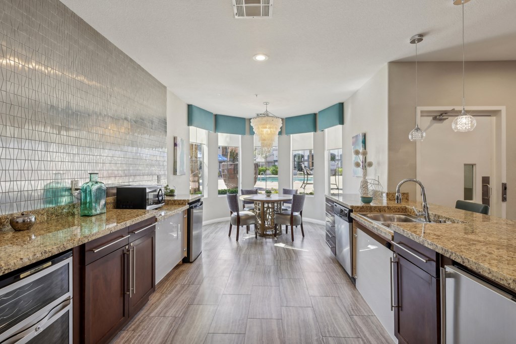 a kitchen with granite counter tops and a dining room with a table