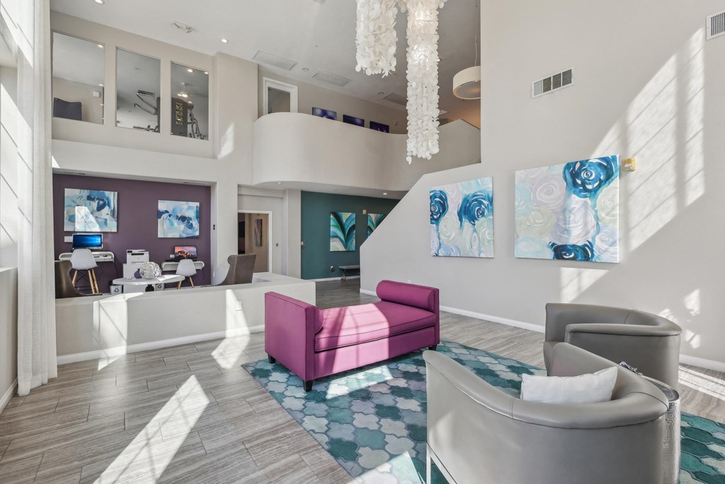 a lobby with couches and chairs and a chandelier