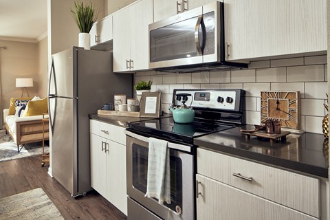 a kitchen with stainless steel appliances and white cabinets