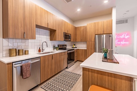 a kitchen with wooden cabinets and stainless steel appliances