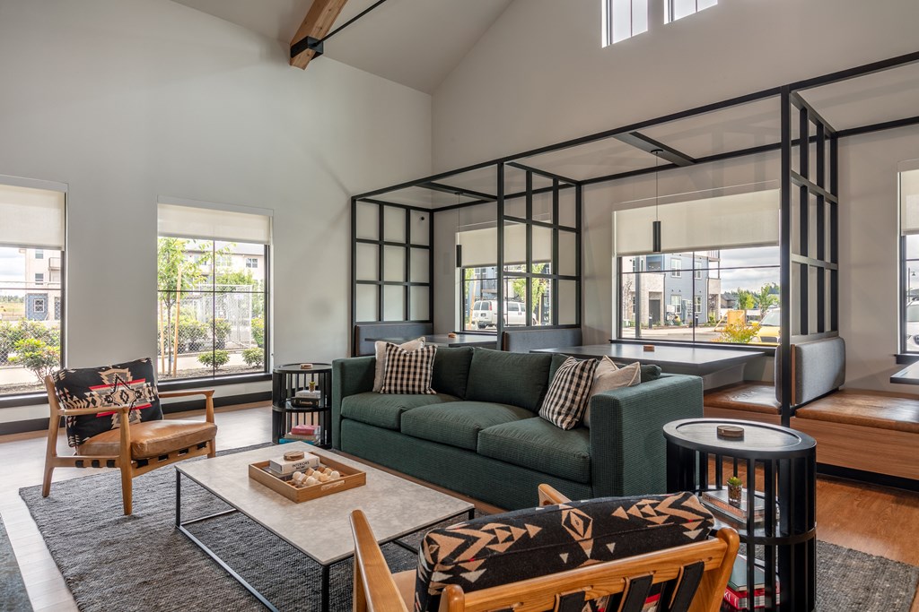a living room with a green couch and a coffee table