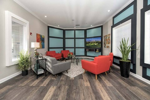 a living room with couches and chairs and a tv
