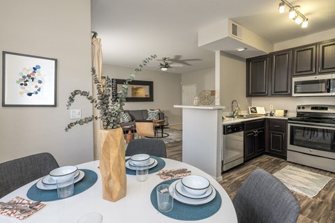 an open kitchen and dining area with a white table and chairs