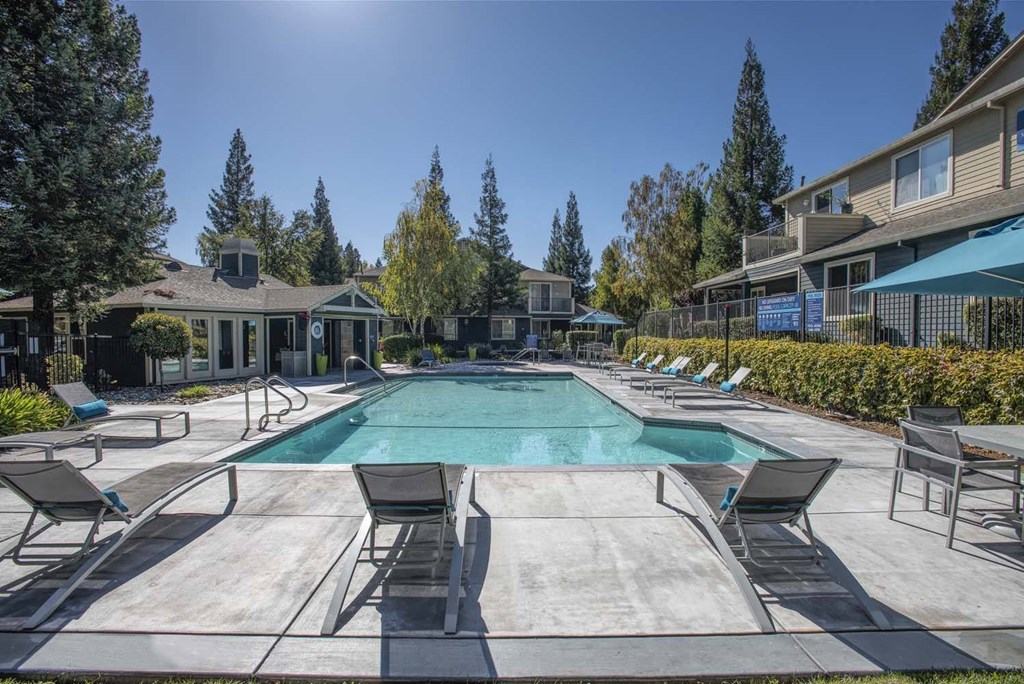 Swimming Pool With Lounge Chairs at Atwood Apartments, Citrus Heights, CA