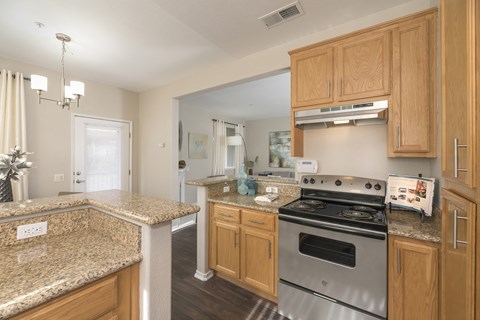 a kitchen with granite counter tops and stainless steel appliances