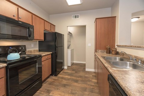 a kitchen with black appliances and granite counter tops