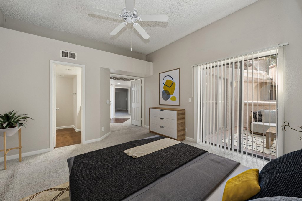 a bedroom with a bed and a ceiling fan