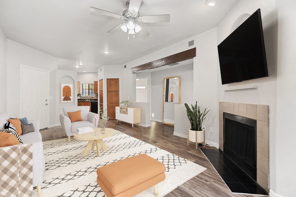a living room with a fireplace and a tv