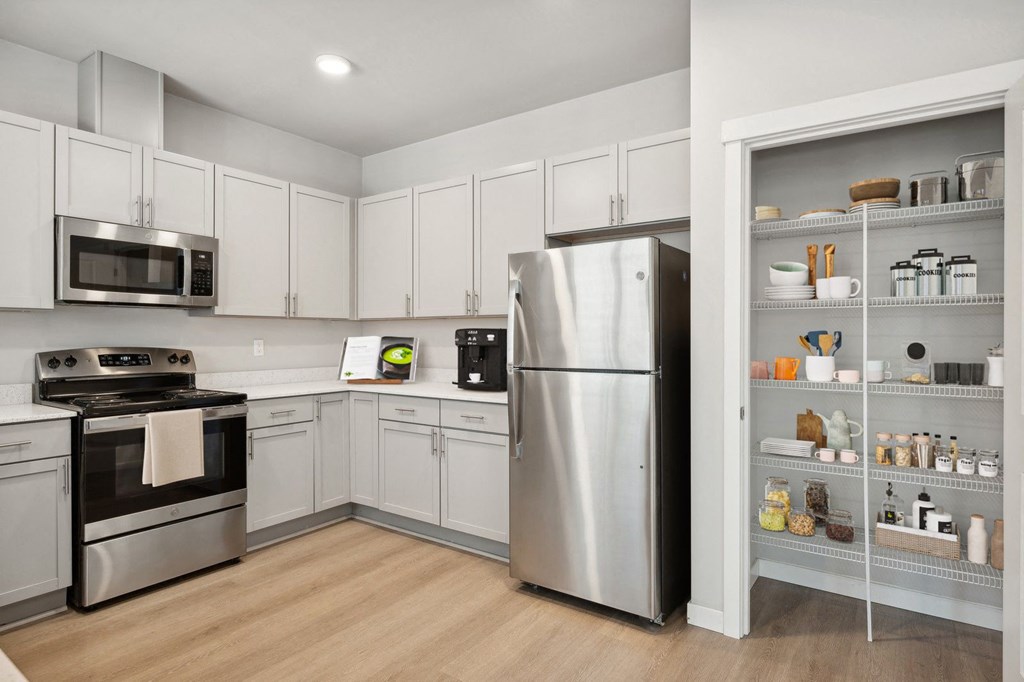 a kitchen with white cabinets and stainless steel appliances